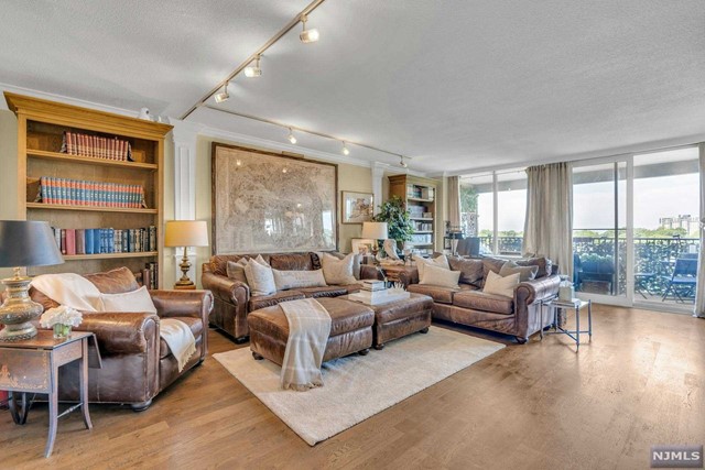 Stunning, move-in ready 2 bed/2 bath corner co-op is the whole package! Terrace is an oasis overlooking lush foliage and spectacular sunsets. Kitchen and baths renovated, tons of closets, the feel of a country-French flat. Large LR w/ faux FP, DR, kitchen w/new fridge, marble counters, built-in Miele coffee maker. Primary suite has Hudson River views, renovated en-suite spa-like bathrm w/ stall shower & heated floor. 2nd BR has walk-in closet. Renovated hall bath w/ tub. Hardwd flrs. Spacious, open-concept w/ huge windows brings in natural light from west, east & north. Horizon House offers gym, deli/convenience store, tennis, playgrounds, 2 pools, hot tub. 24-hr doorman, on-site mgmt. Dogs & cats allowed! NYC/NJ buses across the street. 1 indoor parkg spot, 1 deck. Close to restaurants, shopping, houses of worship, parks. HOA $2763.98/mo (maint $2388.31, Cap Ass $151.67, Cable $62, indoor spot $96, deck spot $66). Min income $133k required for cash purchases.