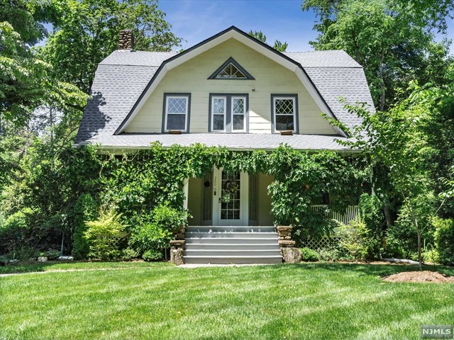 This delightful Dutch Colonial w/ private lemonade porch offers 5 bedrooms & 2F/2H baths. Conveniently located blocks to Elem & Middle school, & Close to NY transportation, vibrant downtown & shopping. Once inside the vestibule you will see the LR is the heart of this home & it leads to a gracious formal DR, with stunning beamed ceiling. The MEIK w/ White Painted cabinets has all Stainless Steel appliances. The upper two floors feature a primary bdrm w/ updated primary bth, & 4 add'l bdrms. Bright & spacious LL features a den, play area, & lndry rm w/ 1/2 bth. Original elements such as rich chestnut trim, 9ft ceilings, fieldstone fplc, original door hardware, & pocket doors blend seamlessly with updates that include new hardwood flooring and custom features which complement the home's timeless character. Amenities are plentiful & include NEW ROOF (2020) a 2C det garage w/ Tesla charger, 2Z heat, central air, outdoor speakers, irrigation, security sys. Don't let this one get away!