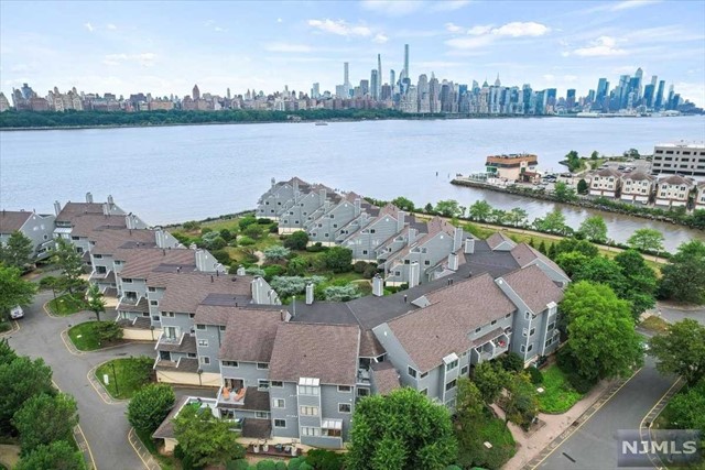 Must see this unique and newly renovated 2-level townhouse at Roc Harbor, a gated community with beautiful landscaping and walkways along the water. The home is situated right on the edge of the Hudson River for luxurious waterfront living and a stunning view of NYC. Approx 2600 sq. ft. with an open floor plan. Features include: hardwood floors, wood-burning fireplace, 2 terraces, high-end kitchen with S/S appliances, private 2 car garage and plenty of guest parking throughout the complex. Easy and convenient commute to NYC...just steps away from the NJ Transit Bus to the Lincoln Tunnel, NY Waterway Ferry and Hudson LightRail to the Path. Close distance to a park, shops, restaurants and much more. Access to the pool at the Watermark and Half Moon w/fee. Some furnitures optional.