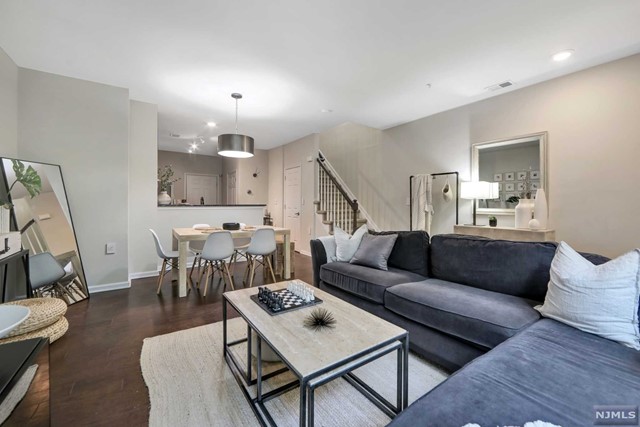 Welcome to Signature Place! This 1,052 square foot unit in a beautifully designed community has 2 bedrooms and 2 full bathrooms. Enter on the first floor to an open concept living and dining room, with engineered hardwood flooring and recessed lighting. The kitchen features granite countertops, glass cut backsplash along with stainless steel appliances. The second floor leads to the primary bedroom, complete with access to the bathroom, along with great closet space. The additional second bedroom provides plenty natural light and could also be used as a flex room/ home office. In unit washer/dryer on the 2nd floor. Signature place community provides a 2,100 square foot clubhouse with a fitness room, kitchenette, billiards room and a POOL!!! Extremely close to all major highways; Rt 46, 80, 21, 17 & the GSP. Don't Miss This Great Opportunity!