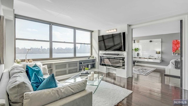 Waterfront living from the comforts of this beautiful, fully renovated 1 Bedroom, 1.5 Bathroom Condo at the infamous 'Galaxy Condominiums, nestled atop the Palisade, in a full amenity High-rise. This home features spectacular panorama views of NYC Skyline & Hudson River, spaciously open floor-plan, complete with costume designed gourmet kitchen with Stainless Steel LG appliances, Quartz Counter Tops, wrap-around Island cabinets for additional storage, a large Living Room Dining Room combine, with direct NYC views with built-in Fireplace, LED Accent Lighting; leading to a lavishly finished Bedroom with sliding design panel doors, in-suite Bathroom, Spa Style Deep Soaking Tub & Frameless Glass Shower Panel, and custom organized walk-in Closets. Other features include a sleek 1/2 Bathroom, Smart Home Technology, Ring Security Cameras, and gleaming Hardwood Floors throughout! In addition, unit is over 1000 square feet of living space; which can easily convert into a 2-Bed.