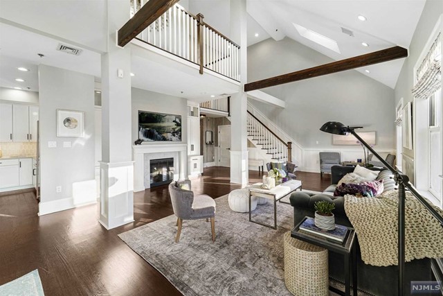 Impeccably renovated, custom designed 2405 square foot DUPLEX LOFT ideally located in midtown Hoboken. PH5A is an expansive, sun drenched 3 bedroom/plus den home, with 3 full baths, boasting 20 foot ceilings, architectural beams, skylights, wide plank oak floors, 5 walk-in closets, and custom built-ins throughout. Featuring a chef's kitchen with custom cabinetry, pantry, quartz countertops, ceramic tiled backsplash, and center island with wine cooler and bar sink, complete with top of the line stainless steel appliances including Wolf Range with vented hood, GE Monogram refrigerator, GE Profile Convection/Microwave oven and dishwasher. A gracious open floor plan allows for entertaining in grand style, cozying-up in comfort in front of your fireplace surrounded by beautiful built-ins, or stepping out to watch the sunset from your large terrace. The bathrooms are superbly appointed with glass designer tile and fixtures.