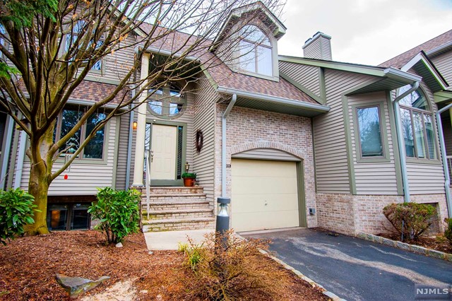 You'll be impressed from the moment you enter this stunning townhome featuring an entry with cathedral ceiling, a sun-filled updated eat-in kitchen that leads to an elegant dining room and living room with a dramatic floor to ceiling stone, gas fireplace, cathedral ceilings and skylights. The dining room opens to your large private deck. The attached garage has plenty of storage with a loft and newer cabinets. The upper level boasts a master suite with 2 walk-in closets a luxurious master bath and another bedroom, full bath and laundry. The ground floor offers another bedroom or family room, office/den and a full bath. All of this within steps to the pool and rec area, tennis, basketball, playground and clubhouse. This entire unit was recently custom painted including the door hardware and hand rails. There is new driveway, alarm and generator. This townhome epitomizes style and tasteful design.