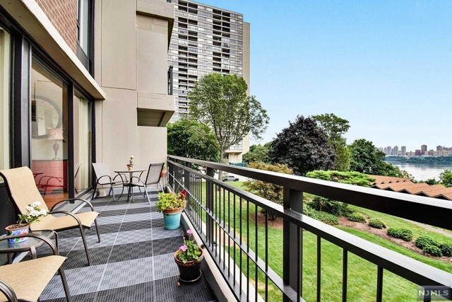 Move right into this 3 bedroom, 2 bath (up-split) unit that is conveniently located on the lobby level. As you walk in you will be greeted by the entry foyer which leads up to the living and dining room and has beautiful plank hardwood flooring. Windows span the length of the living/dining room and offer plenty of natural light. The sliding glass door leads to the large terrace that faces the Hudson River, has views of the city skyline, & overlooks the community's park-like grounds. The primary bedroom has built-in shelving, a generous sized walk-in closet, & an updated full bath with tub/shower. The other two bedrooms have parquet flooring and ample closet space. The hallway also offers 3 additional closets. The second bath is newly renovated with a walk-in shower. This luxury full-service complex offers a 24-hr doorman, community room, 2 pools, gym, tennis courts, playgrounds, & laundry. One indoor garage parking space included. NYC transportation is steps away from the complex!