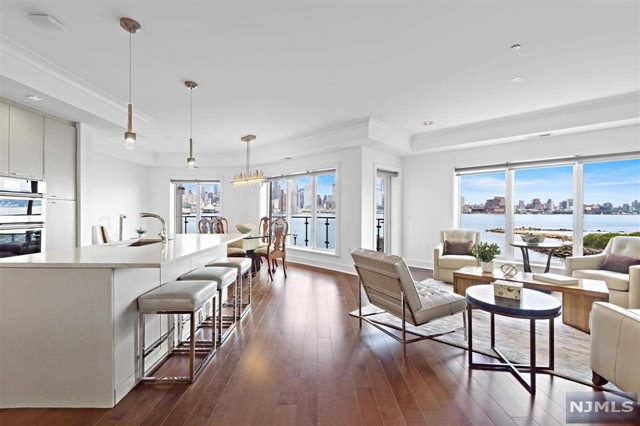 This one of a kind, voluminous 3 bedroom, 3.5 bath, corner residence is sure to please with it's direct East & South unobstructed panoramic views of NYC from all rooms. Be left in awe from the peacefulness of the water & skyline from your over-sized balcony, wrapping from your master bedroom to your living room. The marvelous chef's kitchen is equipped with top of the line Jenn Air appliances, including French door refrigerator, Pro Style Gas cook tops, European style Spazzi custom cabinetry with polished chrome hardware. The south-facing master suite is outfitted with a walk-in closet and en-suite bathroom with a walk-in shower and soaking tub. The home further features, hardwood floors, 2 car garage indoor parking, full size whirlpool front load washer & dryer, and much more. Community offers concierge services, club room, theater room, children's play studio, an outdoor patio with fire pit, swimming pool and much more! Do not miss your opportunity to own this view today!