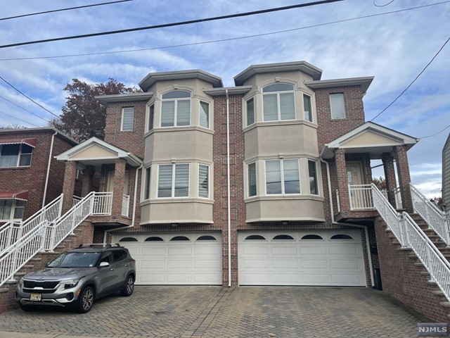 Excellent opportunity to live in Palisades Park. Wonderful details throughout the home. Living room with fireplace and hardwood floors through the property. Spacious modern eat in kitchen with stainless steel appliances and sliding door to deck. Second floor features a large Master bedroom with full bath and jacuzzi tub. 2 bedrooms with full bath and laundry room. Finished basement has an office or extra bedroom suite with a full bath. This house conveniently located within walking distance to NYC transportation and an easy access to NJ major highways and shops. Don't miss seeing this lovely home.