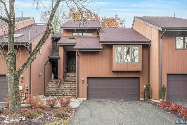 Move right into this very sun-filled renovated Fernwood model in the sought after Woodlands Community. Generous living space, soaring high ceilings, wood-burning fireplace, newer gourmet kitchen, master en-suite with new bathroom, never been exposed wood floors throughout beneath all carpet, two-car garage, private yard with deck. Great outdoor space. Immaculate & well maintained. Wonderful location in the community, near pool, tennis, and clubhouse. Enjoy all the amenities the Woodlands has to offer. Conveniently located to NYC shuttle at the entrance to community, houses of worship, shopping, dining, & recreation & don't forget the fabulous town of Montclair is close by. Don't miss this fabulous opportunity. to own in the charming Woodlands community