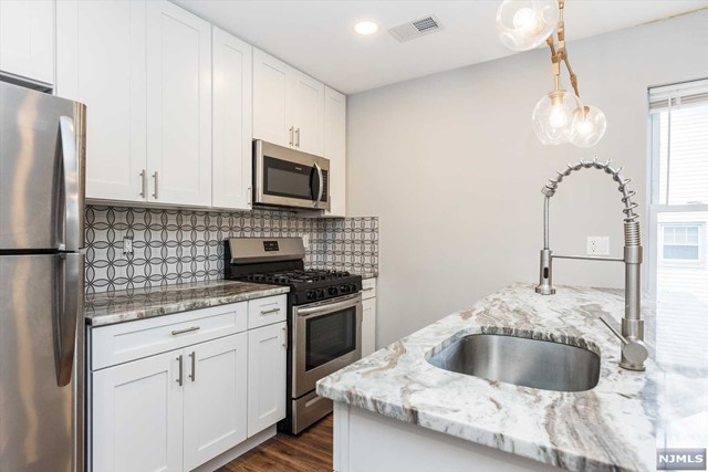 Renovated 3-bedroom, 2-bathroom, 2nd-floor apartment nestled in the heart of Bloomfield. Located near NYC transportation hubs and an array of Bloomfield's finest dining and shopping destinations, convenience is at your fingertips. Step into your private entrance to be greeted by a modern, open floor plan that seamlessly integrates the spacious living area with a large kitchen boasting a kitchen island, stainless steel appliances, and a dishwasher. Simplify your life with in-unit laundry facilities and central air conditioning, ensuring comfort year-round. Retreat to the primary bedroom, featuring an en-suite bathroom and generous closet space, while the two additional bedrooms offer ample accommodation. Included is one covered parking spot, with an option for an extra space at an additional fee. The shared backyard space is perfect for outdoor relaxation and entertainment. Don't miss this opportunity to experience easy, stylish living at its finest. More photos to come!