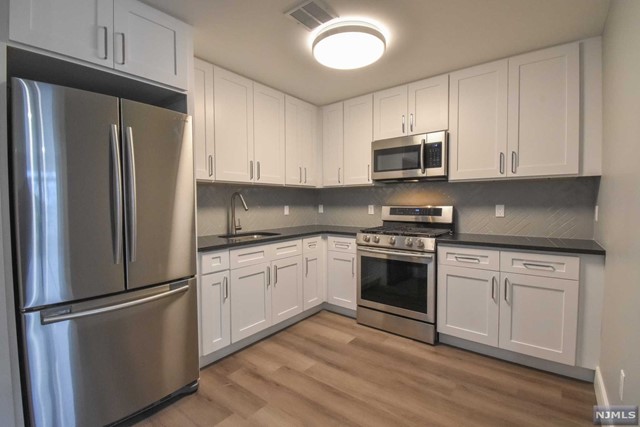 Sunny and bright top floor one bedroom one bath with beautiful features including top of the line appliances and high end finishes throughout ! Spacious open floor plan with Wifi and Video Intercom System built in. Central air and laundry IN UNIT - Tentant pays utilities. Pet friendly. One assigned parking space in garage included ! Near bus and lightrail. It is a Commuters dream!!! Come claim your unit!!