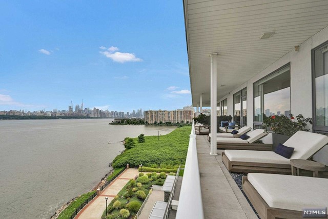 Luxury living at its finest in this stunning 3-bedroom, 2.5-bath penthouse in the prestigious Glass House in Edgewater. With extensive designer upgrades, this residence offers unparalleled sophistication and comfort. The spacious interior features sleek modern design, 10' ceilings, complemented by breathtaking New York City skyline views. Entertain effortlessly in the expansive living areas, or unwind on the large wrap-around balcony, perfect for enjoying sunrise to sunset views. Gourmet kitchen equipped with Miele, Wolf and Subzero appliances and a custom eat-in breakfast nook. Spacious bedrooms have spa-like baths and custom closets, as well as a laundry room. Two parking spaces included. Additional highlights include smart home technology, security and audio throughout. Building amenities include a NYC-facing swimming pool, rooftop deck, cabana areas, firepits, fitness center, movie theater ,reception room, playground, concierge, private ferry shuttle & NYC bus.