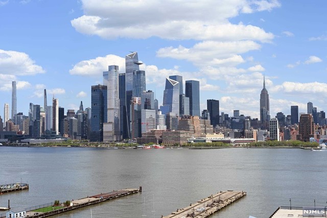 Experience stunning, unobstructed views of the Hudson River and New York City skyline from the GW Bridge to the Freedom Tower! Luxuriate in this pristine, expansive corner unit featuring a double living area opening onto an east facing terrace. This exceptional home is appointed with a dedicated dining space, bonus den/playroom and walk-in custom designed pantry. The open kitchen features Viking appliances and an oversized island. The primary bedroom suite has three beautiful exposures- south, east and west- a thoughtfully planned walk-in California Closet and private en-suite bathroom. The large second bedroom has outstanding views as well, and generous closet space. The oversized living space can easily be adapted for an additional bedroom. This fabulous home is located in Maxwell Place, a full amenity luxury hi-rise building including 24hr concierge, state of the art health club, rooftop pool with hot tub, theater/screening room, exclusive resident's club.