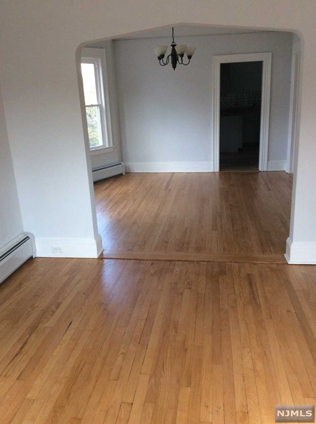 BEAUTIFUL 2 STORY APARTMENT(2ND & 3RD FL) DRENCHED WITH NATURAL LIGHT. FRESHLY PAINTED, WOOD FLOORS ON BOTH LEVELS. LARGE LIVING ROOM & DINING ROOM, EIK WITH NEWER APPLIANCES, WASHER /DRYER ON CLOSED PORCH, UPDATED FULL BATH AND BR/OFFICE COMPLETE THIS FLOOR. TWO ADDITIONAL BEDROOMS UPSTAIRS WITH LOTS OF CLOSET SPACE. ONE CAR GARAGE AND USE OF YARD. TENANT RESPONSIBLE FOR LAWN AND SNOW, LAWNMOWER AND SNOW BLOWER SUPPLIED BY LANDLORD. DON'T MISS THIS LOVELY WELL MAINTAINED APARTMENT! EASY COMMUTE TO NYC, CLOSE TO HIGHWAYS AND SHOPPING! AVAILABLE 1/15