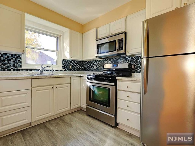 AMAZING LOCATION/BEAUTIFUL APARTMENT: One floor living in this spacious two bedroom unit located on the first floor. Features new floors, two large bedrooms with windows, newer kitchen, separate dining area, large living room and a full bath. Extremely close proximity to two different NY bus lines. Laundry facility on site, hot water and heat included with rent. 2 outdoor parking spaces included. Near shops, restaurants, and blocks away from the Paramus malls. Garage can be rented as it becomes available.