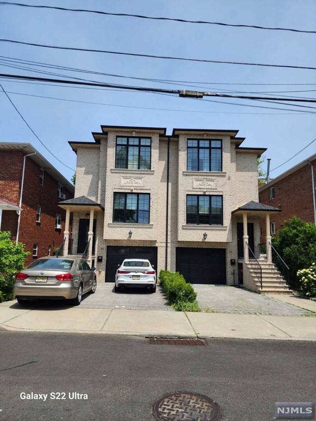 ONLY 6 YEARS OLD, THIS 3 LEVEL TOWNHOUSE HAS ALL THE SPACE YOU NEED WITH ALL THE CONVENIENCE AND SKY LINE OF NYC. ALMOST 3000 SQ FT OF SPACE, THIS BRIGHT HOME FACES SOUTH, COMES WITH GLEAMING HARDWOOD FLOORS IN LIVING ROOM W/ GAS FIREPLACE, AUTOMATIC ROMAN SHADES, FORMAL DINING ROOM, EAT IN KITCHEN AND PRIVATE TERRACE WITH A POWDER ROOM. @ND FLR FEATURES MASTER BEDROOM WITH TRAY CEILINGS, MASTER BATH WITH DOUBLE SINKS, SHOWER AND SOAKING TUB PLUS 2 SPACIOUS BEDROOMS AND FULL BATHROOM. ALL BEDROOMS HAVE CALIFORNIA STYLE CLOSETS WHICH CAN BE ADJUSTED TO YOUR LIKING. GROUND LEVEL HAS ATTACHED 1.5 CAR GARAGE W/ EPOXY FLOOR, FULL BATH AND RECREATION ROOM - IDEAL FOR HOME GYM, OFFICE, NANNY OR MOVIE ROOM, EVEN HAS AN ENTRANCE TO A PRIVATE PAVERED YARD. NOTHING TO DO BUT ENJOY THE NYC SKYLINE!! NO PETS NO SMOKING.