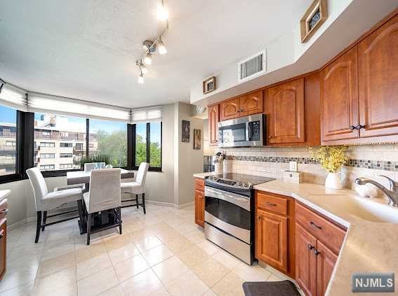 A commuters dream at World Plaza hi-rise luxury building located on the highly sought after Prospect Ave section of Hackensack! This bright and beautifully renovated 6th floor condo has the perfect floor plan - 1 large bedroom with walk-in closet + custom shoes closet, 1 full bathroom, a large kitchen with breakfast nook, dining room, and living room with 3 spare closets! Home features 4 wall AC units, brand new dishwasher, new light fixtures, new recessed lighting, new wood accent wall and parquet hardwood floors throughout. World Plaza is a spectacular place to live - close to Paramus malls, shopping, Rt 4, 17 & 80 and a block over to Hackensack University Medical Center. Low $578 monthly HOA fee includes water, outdoor pool, renovated fitness center gyms, new elevators, 24 hour security doorman, concierge, laundry room on each floor, garbage disposal and recycling on each floor and plenty of guest parking available. Assigned Parking is available: $75 indoor or $50 outdoor.