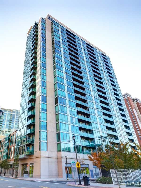 Welcome home to this 2 Bed 2 Bath corner unit with a Private Balcony and stunning views NYC! Chef's kitchen, newly renovated in 2022, features Calacatta white quartz countertops, Cubitec modern shaker cabinets, stainless steel appliances and a large breakfast bar with a waterfall quartz countertop. The large master bedroom is equipped with a large walk-in closet and a luxurious spa like en-suite bath with double vanities. Large floor to ceiling windows, allow for tons of natural light all day long. Home features hardwood floors throughout, central heat/AC, and an in-unit Bosch washer/dryer. Building amenities include: 24/7 concierge, fitness center, jacuzzi, sauna, stream room, resident lounge, conference room, playroom and a roof deck with amazing NYC/River views! Prime location close to Newport & Hoboken PATH, Ferry, NJ Transit Train, Light Rail and Bus Terminal.