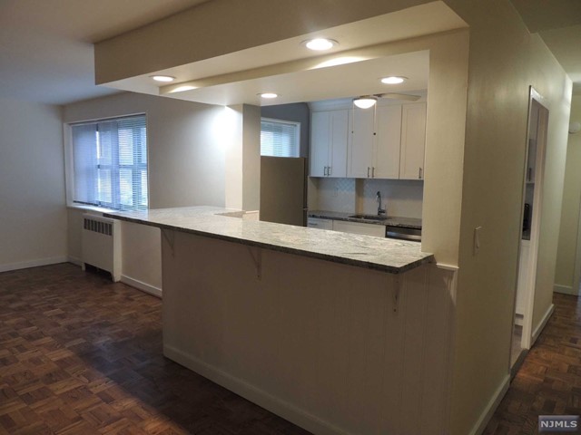 Discover Berkley Arms! Totally REDONE mid rise elevator condo in the heart of the prestigious Fairmount area of northern Hackensack. All NEW open kitchen with breakfast bar seats at least 4 & features loads of Fabuwood soft close cabinetry & granite counters. REDONE/retiled bathroom, like NEW refinished wood parquet floors. One reserved parking space. Pool & picnic area. Just 2 short blocks from NYC train (Anderson St. station); near NYC & local buses and Aldi, Target etc.