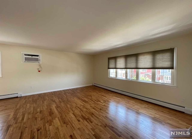 Gorgeous 2nd floor apartment recently renovated and ready for quiet enjoyment! This unit features a very bright and large living room and dining room with hardwood floors throughout. Beautiful kitchen with plenty of cabinets and granite counter tops with stainless steel stove top and wall ovens. Bathroom is fully renovated as well with a stand up shower, 2 very good size bedrooms, renovated 1/2 bath and a small room that can be used as a home office or for additional storage. On street parking