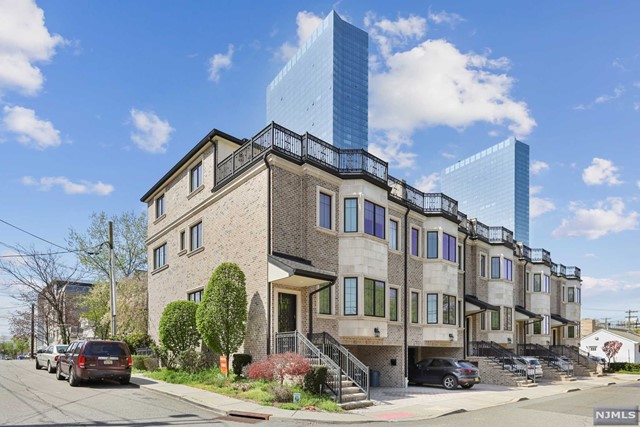 Location and luxury... this custom built masterpiece is located on a surprisingly quiet street in the heart of Fort Lee, NJ. This 4 BR / 3 Full and 2 Half BA townhouse boasts 10' ceiling heights, elevator, hw floors throughout, amazing GWB views from rooftop terrace, gourmet chef's kitchen, radiant heated floors in select areas, and central vacuum. Additional features include entertaining space on 3rd floor with wet bar, fireplace, ground level Rec Room, and oversized garage. Huge owner's suite with 2 walk-in closets, luxurious MBA, and tray ceiling. Junior suite on 3rd floor is perfect for privacy or guests. Impeccable attention to detail with architectural trim and crown molding. Close to shops/restaurants, theater, transportation, schools, worship, major highways, and GWB.