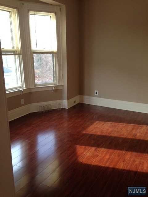 Great clean, airy and bright one bedroom unit consisting of living room, full bath and eat in kitchen. Refrigerator and stove provided by owner plus Utilities included in rent. Photos are from previous tenant moving in. Unit was painted in 2021. Hardwood flooring - lots of windows, use of backyard. Great location near West Hudson Park. Street parking, no laundry available. Tenant responsible to pay the Realtor's Rental Fee of $1,400