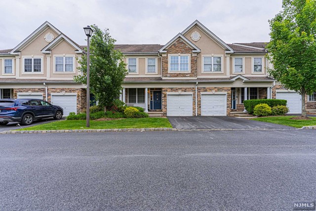 Welcome to Grandover Pointe-newer & spacious townhome community! Just steps away from NYC transportation, great schools, shopping, & major highways ! 1st floor features a front porch, high ceilings, EIK with breakfast bar, separate dining, & sliders to deck. Open concept living & dining rooms w beautiful hardwood floors. The entire space is elegant & beautiful, perfect as a retreat or for entertaining! You will enjoy the gracious family room & a fireplace (as is-no known problems). Step upstairs to the primary bedroom retreat: high ceilings, lots of windows, recessed lighting, two walk-in closets, full bath with shower, jetted tub & double sinks. Plus 2 more spacious beds, main bath & laundry room. Impressive fully finished walkout basement w high ceilings, additional space footage & a private patio! Wayne offers: great schools, Whole Foods, Trader Joe's, PAL, Boys & Girls Club. Y, James Roe Pool, Michael Kilroy Memorial Park & more.