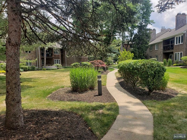 Carefree & comfortable living in the desirable TULIP GARDENS community located in the heart of town! Everything is on one level with a layout offering terrific space on the 1st floor plus an oversized private garage. An impressive kitchen with all custom finishes, high-end cabinetry, quartz countertops, 5-burner stove & much more. The primary bedroom suite fits a lot of furniture and has a huge walk-in closet w/shelving. A large sun-filled living room w/fireplace & sliding glass doors open to a patio. Features include a sizeable laundry room with newer washer & dryer, Hunter Douglas window treatments throughout, new flooring, new hot water heater & recessed lighting. The reserved parking spot is right in front of the building. Shopping, restaurants & transportation are a stone's throw away (bus near entrance & train station less than a mile). Close to schools (Blue Ribbon district). Beautifully landscaped grounds to enjoy in a peaceful setting!