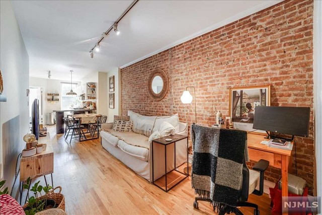 Experience the charm of Hoboken in this beautiful one-bedroom condo on Park Ave. As you step inside, you're greeted by an open-concept living area that seamlessly combines the living room, dining space, and kitchen. The layout maximizes space and creates a bright and airy atmosphere. Large windows allowing natural light to flood the entire space and provide a warm ambiance throughout the day. Exposed brick walls adorn the living room and bedroom. The open design ensures a seamless flow between the spaces, creating a sense of unity. The kitchen is well-appointed and equipped with modern appliances and ample storage space. The bedroom offers a tranquil retreat with large windows and wood shutters that ensure plenty of natural light and creates a serene atmosphere. A prime location with close proximity to the PATH, NJ Transit Bus, and Hoboken's finest restaurants, shops, and bars!!