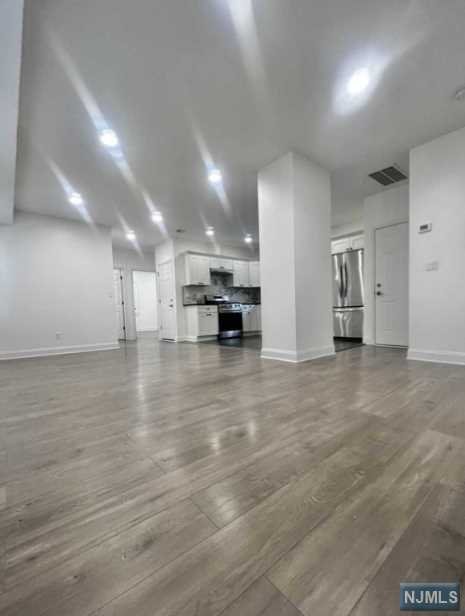 Welcome home to this freshly painted gorgeous bright spacious Renovated 2nd floor unit in two family house. Features include: Open floor concept LR/DR/Eat in kitchen, granite counter tops, lovely tiled back splash, two bathrooms with beautifully tiled showers/floors, hardwood flooring, stainless steel appliances: Gas stove, refrigerator, dishwasher, Central AC! Wide load Washer/Dryer! Utilities included: Cold water. One parking space in driveway provided. There also is street parking on quite street available. No backyard access. Pets conditional with monthly pet fee.