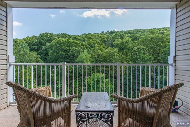 Great opportunity to purchase rare to the market 3 Bedroom, 3 Bath Penthouse at Wanaque Reserve, 55+ adult community. Stunning Mountain Views and Spacious interior spaces define this spectacular property. The features include 2 Primary Suites with en-suite baths, walk-in closets, gourmet kitchen offering granite counters and stainless steel appliances, expansive living room with custom built-in cabinetry, formal dining room with crown molding and wainscoting, French doors opening to den, TWO balconies overlooking the private, wooded outdoors. High ceilings, gorgeous mill work and hardwood floors. Loads of storage with additional storage space available, 2 garage spaces. Freshly painted in decorator neutral. Nothing to do but move in!
