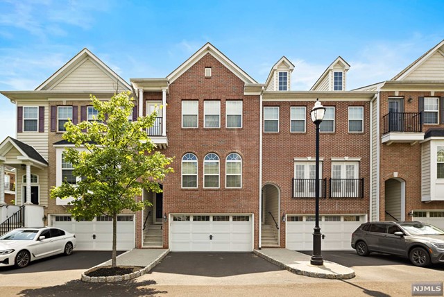 Exquisite, move-in ready 3BR townhome in Creekside Ct offering 2,369 sq. feet of living over 3 floors and 1.5 car attached garage. Hardwood floors run throughout the main floor through a large living room, formal dining room and modern kitchen with stainless steel appliances and granite tops and island. Large family room off kitchen along with door to beautiful terrace. Venture upstairs to your master suite with a master bath and walk-in closet. 2 additional bedrooms upstairs with a full bath off hallway and large washer/dryer room. The ground floor offers another large finished space with 1/2 bath. Complex is in a prime location adjacent to the state of the art town recreation center with gym, indoor track with views of NYC skyline and pool. Town pool lies across the street along with Schmidts Woods. Steps to high school.