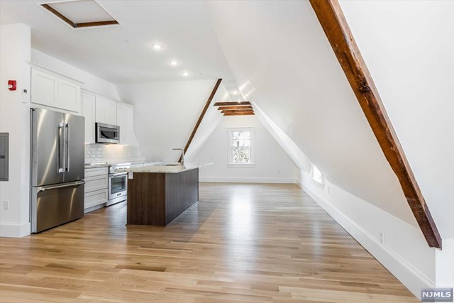 Magnificent craftsmanship and bright spaces come together in this stunning top floor, 2 bed - 1 bath apartment with HVAC and Laundry IN-UNIT. Vaulted ceilings, custom windows, exposed brick & beams, plus gleaming hardwood floors create an unmatched feeling of "Home". No detail was spared in highlighting period architectural details, while catering to more modern needs. Each bedroom features triple closets and the primary bedroom offers expertly handcrafted storage details. The kitchen offers a high end Thermador appliance package (induction range), complemented by an abundance of custom cabinetry and a healthy center island. There is also a shared front patio for winding down with some afternoon sun. Available Immediately. Dogs reviewed case by case. 2 Car Parking included. Tenants pay only Electric for all heating and cooling, energy needs.