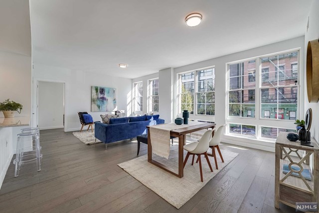 This well-appointed 2bed/2bath home spans over 1336 sf, in a steel and concrete boutique building with elevator and parking. This unit has an expansive open layout living room/dining area giving you plenty of space for entertaining and relaxing. Facing east with floor-to-ceiling windows, it is flooded with natural sunlight. Enjoy cooking in your very own chef's kitchen complete with breakfast bar, Viking 5 burner stove/oven, custom cabinetry, and quartz countertops. The home features an in-unit full-size washer/dryer and is fully outfitted with California Closets, and hardwood wide plank floors throughout. The primary bedroom features a huge customized walk-in closet and an en-suite bath with a double sink vanity, standing shower, custom marble tile, and separate soaking tub. A split floor plan layout provides full privacy for each bedroom. Building amenities include a full gym, a manicured shared yard fully equipped with a fire pit and BBQ, as well as an additional roof deck.