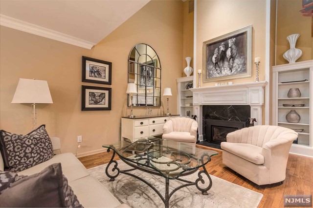 Welcome to prestigious, lushly landscaped Brookside Manor, where resort style living will begin. Enter this end unit townhome through a private side door into a spacious foyer accented with crown molding & French doors leading to a handsome library. Entertain in style with an open, airy floor plan. Your guests will enjoy hors d'oeuvres in front of a granite gas fireplace highlighted by custom bookshelves. Every culinary artist will enjoy meal prep in the master chef's kitchen offering state of the art stainless steel appliances. Days end retire to a sumptuous primary suite offering an exquisitely updated tiled bath with oversized shower. So much more, hardwood floors throughout, newer high efficiency furnace & central air conditioning systems. Simply place your furniture to let a new lifestyle, with pool, walking paths, tennis courts, playground & club house begin. Convenient to NYC transportation, top rated public schools, parks & recreation. Owner holds NJ Real Estate License.