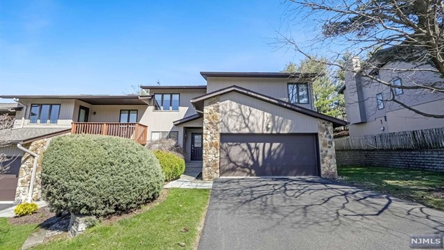 2600 sq. ft. of living space (including fin. portion of lower level). Move-in ready end unit w/3BR, 2 full& 2 half bths., 2 car gar. Freshly painted interior, updated kit. w/granite counters & backsplash, cherry cabinets, SS appl. breakfast nook, all HW floors on main & upper levels except for kitchen, baths foyer (all tiled). Upper level has 3 BR & 2 full baths. Lower level is light & bright with media rm/FR, office, exercise rm & half bth. Located on beautiful Garret Mountain, Wedgewood Knolls enjoys spectacular sunsets & offers outdoor pool, clubhouse, tennis & pickle ball, and a bocce court. Great commuting anywhere with Rts. 46, 3, 80, 23, & GSP nearby, 3 min. to MSU train station w/1250 car parking garage and Midtown direct trains to NYC, 5 min. to Allwood Bus Park & Ride to NY Port Authority. Fine dining, boutiques and shopping in Montclair less than 10 min. Supermarkets, and other conveniences 3 min.