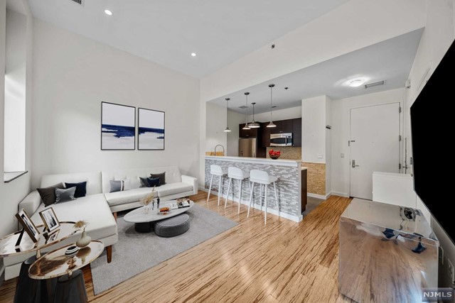 Rare Studio + Sleeping Alcove condo on an upper floor in the ultra-desirable Hamilton Square building. Amazing location across from Hamilton Park. Open-Concept kitchen with quartz countertops, a breakfast bar & SS appliances. LAUNDRY IN UNIT! Generously sized sleeping room. Spacious tiled bathroom with radiant heated floors. Oversized windows, high ceilings, recessed lighting, and bamboo flooring. 1 Storage unit in the building is INCLUDED. Hamilton Square is a full service doorman building with several common outdoor areas including a rooftop terrace complete with grilling stations. Ground level courtyard off the main lobby. Pet-Friendly building. Available to residents is a discounted membership to nearby health club. Convenient to Path, NYC transportation, Hamilton Park, restaurants and more! 25 Year Tax Abatement. Currently in year 15. Parking details available upon request!