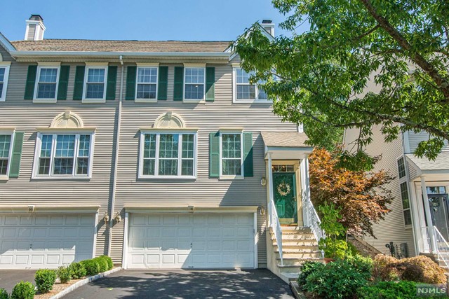 Welcome Home- Desirable Stonebridge Townhome community, amazing condition with tons of natural light and beautiful private outdoor living space! End unit Townhome features: inviting formal living and dining rooms leading to great room with wall of windows filling the home with sunshine, soaring two story ceilings, fireplace and open floor plan. The kitchen has a breakfast bar, stainless steel appliances, pantry, eating area, and sliding glass door leading to the outdoors. Wonderful patio to enjoy the sanctuary overlooking the woods for a quiet night at home or fun with friends. Upper floor includes: All large bedrooms and lovely primary suite: walk in closet, cathedral ceilings, full bathroom with double sinks, jetted tub and stall shower. Finished lower-level recreational room perfect for den, office or playroom. First floor laundry room, recessed lighting, hardwood floors, and meticulously maintained by owner. Enjoy community living and tennis courts. Great Location.