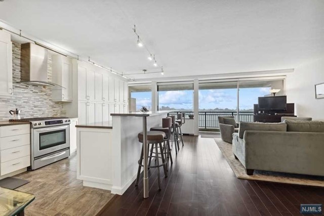 TOTALLY RENOVATED!!! Beautiful 3 bedroom/2 bath DOWNSPLIT Duplex Townhome style home on 3-Levels with views of NYC,THE HUDSON, and GWB that can only be found at Fort Lee's Horizon House co-op. Upgrades including Hardwood Plank Floors throughout, Custom Open Kitchen with HUGE Breakfast Bar Designer Appliances, Custom Closets-BRIGHT Home with Entry Foyer leading to a Living Room/Dining Room...Floor to ceiling windows w/24' terrace providing an abundance of sunlight w/no obstructions. All bedrooms on lower level- Featuring private suite with walking closet Walk-In Closet,and Renovated bath. There are 2 additional rooms which can be Bedrooms,a Den,or Office! There is also a 2nd full bath. Located minutes from NYC! MONTHLY FEES TOTAL $2926.16 (MAINT$2457.18,PARK $108,CBL/INT$48.90,ASSES$312.08) INCLUDES ALL utilities,Taxes,Parking,and u/l mortgage. Board approval req. Min. Gross income for cash buyer w/no debt $140k. Contact Halley Natkin Coldwell Banker Fort Lee(917) 626-8240