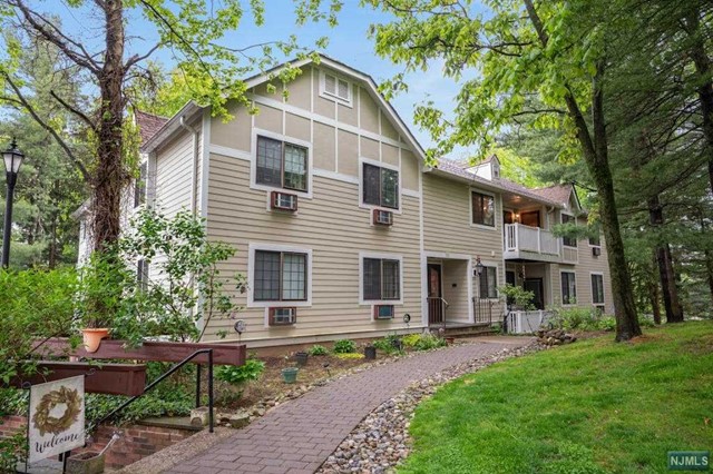 Welcome to Foxwood, a beautiful condo community tucked in the woods of Morris County. Enjoy a carefree lifestyle in a private setting. Move right in to this 1 bedroom, den or 2nd bedroom, 1 full and one half bath condo--best location in complex with private courtyard. Open airy feeling throughout-- Living room, Kitchen has room for table with pass thru to Dining Room. Primary Bedroom is located in the back away from living area which gives nice privacy. Full bath has vanity w/double sinks, tub/shower and tile flooring, stacked washer & dryer in unit and wonderful closet space. Relax on your deck which has room for a small table and chairs.New flooring, updated electric, new dishwasher, and AC units. An added plus is the large storage unit in the basement. HOA fee includes heat, water, and sewer--just pay your electric. Amenities incl. an outdoor pool, tennis and basketball courts. Foxwood is a pet friendly community.