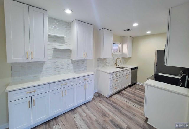 Just one block away from the New Downtown! Conveniently Located close to Bus Stop and walking distance to Essex St. Train Station. Brand New Kitchen Cabinets and Quartz Counters, Soft-Close Cabinets and Stainless Steel Appliances. Large Living & Dining Area with Fireplace. New Flooring Throughout, Freshly Painted and Move-in Ready! Central Air, Private Balcony with entrances from Primary Bedroom and Living Room. Washer/Dryer in unit! Two Parking Spaces included! Just steps away from Hackensack Performing Arts Center, Restaurants, Stores and More! Listing agent related to owner.