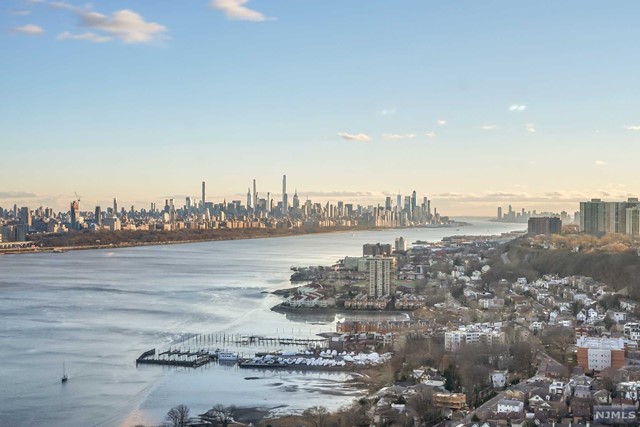 Beautiful, luxury, sun drenched condominium at The Palisades in Fort Lee. Step into this home and see spectacular, sparkling, Southeast NYC and Hudson River views from every wall to wall window. Most desirable, very spacious, three bedroom, three and 1/2 bath (6 Line) with lots of closets, beautiful Stained Toffee hardwood floors throughout, new washer/dryer. Deeded storage closet on the 10th floor, 2 indoor tandem parking spots with electric outlet permit, just a short distance from the elevator. Amenities include resident's gym, community room, library, children's playroom, conference room, outdoor barbeque,swimming pool, beautiful promenade with NYC views, and a Cafe. This pet friendly building is close to restaurants, shopping, Houses of Worship and New York transportation. Maintenance is $1168.82 + 260.21 assessment until May 2027= total maintenance $1429.03