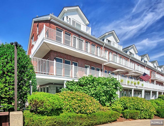 Reside on a private peninsula with the ambiance of an Old World water Village. Likely most inside and outdoor space of any corner unit on the waterfront!! 617 sq ft of decks and 424 sq ft patio. World class NYC views!! The excitement begins on the ground level with a spacious family room/bedroom that leads to an extra large patio. Full bath. Private elevator. The next level boasts designer kitchen boasts custom cabinetry with granite counters, stainless steel appliances and bay window. Open living/dining area leads to a fabulous wrap-around balcony. Corner fireplace. The third level is a lavish Master suite with an enlarged deck, and exotic wood built-ins and walls. Sumptuous master bath with high end fixtures, large custom shower and Jacuzzi tub. Loft area with bedroom and bath; could be used as two bedrooms. Custom built-in office. Parking for four cars; two inside and two in driveway. Community features two pools and jacuzzis, tot lot, and free shuttle to Ferry and Light Rail.