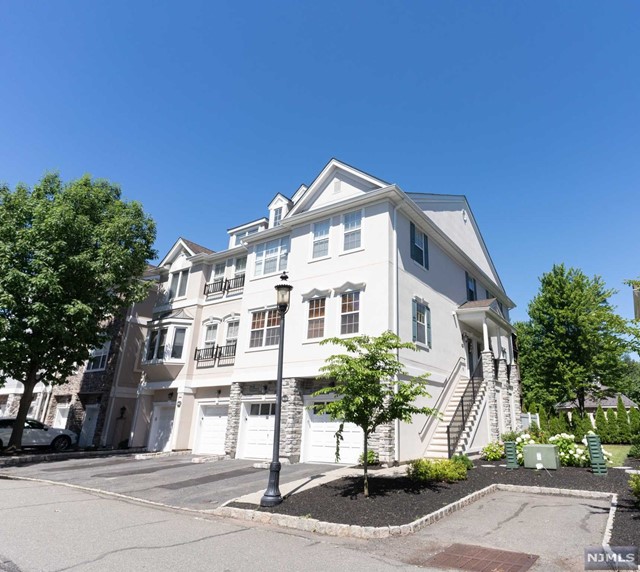 Welcome to Cambridge Crossings! Look no further than this tastefully Modernized End Unit Townhouse minutes away from major highways,NYC bus and train.Private gated community filled with amenities including pool, gym, clubhouse, and more! This multi-level home features 2 beds and 2.5 baths plus huge family/rec room on ground floor. Walk into the beautiful first level with gleaming hardwood floors, bright open concept living room with fireplace, dining room, fully updated kitchen ,huge deck and down the hall you have a spacious bedroom and master bedroom with huge walk in closet.Walk down the stairs and you're greeted into spacious rec room/family room, spacious laundry room, powder room, utility room, patio and garage. Ample closet space throughout and high ceilings in every room!Don't miss your opportunity to live in elegance and luxury!