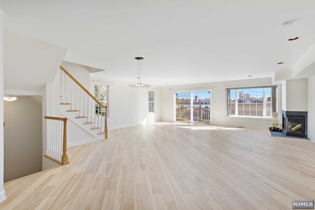 Rare opportunity! Beautifully Renovated Charming, Finely Appointed Triplex Townhouse in a private community in the heart of Edgewater features spacious open layout. Renovated kitchen and baths w/ white/gold quartz countertops, kitchen subway tile backsplash, newer stainless steel appliances, recessed lights throughout, cozy natural fireplace, newer bedrooms floors, and reconditioned wood floors in living room. Bask in NYC views on deck and bay windows, and so much more - it's a MUST SEE! Finished Basement/ Recreation/ Den, Tons of Storage, Private 2 Car Garage, Plenty of visitor parking. Dream Commute to NYC via NY Waterway Ferry & NJ transit bus only steps away, in the midst of walking distance to Whole Foods Market, Trader Joes, Starbucks, only seconds from town surrounded by restaurants, retail, salons, parks, and elementary schools. Family lifestyle w/ Urban Flair! DON'T MISS OUT! WON'T LAST!