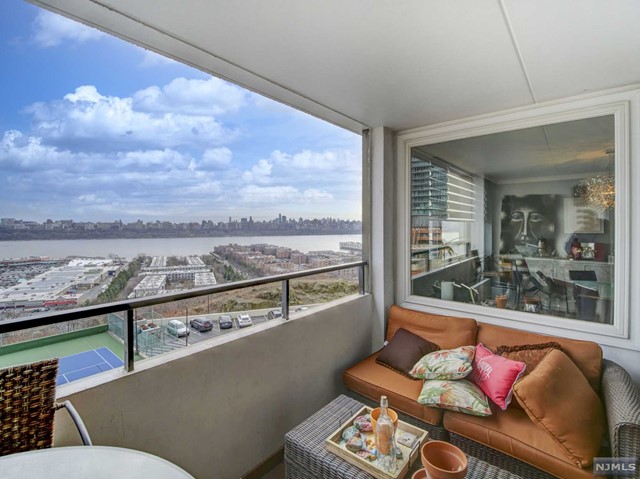 Beautiful, upgraded, 3 BEDROOM, 2 BATH CORNER UNIT with sliders to TERRACE. Spectacular, unobstructed views of NYC and the Hudson River - perfect for entertaining! Huge living room/dining room area and features electric blinds, chandeliers and recessed lighting. Gorgeous kitchen featuring newer, stainless steel appliances, granite counters, and breakfast bar. The Primary Bedroom En Suite features two large walk-in closets and full bath with shower stall. Updated bathrooms, amazing lighting. Tons of closet space throughout. New flooring in most rooms. Multi million dollar newly renovated building with no assessments. Amenities include an Olympic-sized pool, Jacuzzi, 24hr doorman, gym, tennis, new yoga room, and more! Very convenient to NYC transportation - bus (across the street) and ferry! Maintenance fee includes amenities, taxes, basic cable, internet & water. LUXURY LIVING AT ITS FINEST!