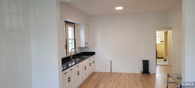 Large updated 1 bedroom unit with open floor kitchen and large dining room/living room area. One block from supermarket, walking distance to shopping and restaurants. Near transportation including 3 blocks from train station. Gas range, refrigerator, heat and hot water included. Garage spot may be available for extra.