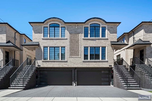 Exceptional Modern 4 LEVEL Townhouse boasts an expansive 3800 sq ft of living space built in 2018, offering Best Views in town. Step into the Main Level, where 9' ceilings, oak hardwood floors, exquisite custom trim and molding create an atmosphere of elegance. Modern eat-in kitchen with PANORAMIC VIEWS, custom cabinets, top-of-the-line appliances. Relax in the family room by the fireplace with an outdoor Deck. Master Bedroom on upper level with heated flooring, ensuite spa-like bath and generous His and Her walk-in Closets. Plus 2 bedrooms with a full bath. On ground level, discover a 2-car garage, Bedroom/Family Room with Full Bath, and another Deck for outdoor enjoyment. Finished Basement offers REC Room, Full Bath, and side Entrance leading to the yard. Premium features such as deluxe tile packages, Nest thermostats, recessed lighting with multi-function dimmers, Soft Water system, Baseboard Heating, central vacuum enhance the luxurious experience. NYC BUS STOP RIGHT IN FRONT.