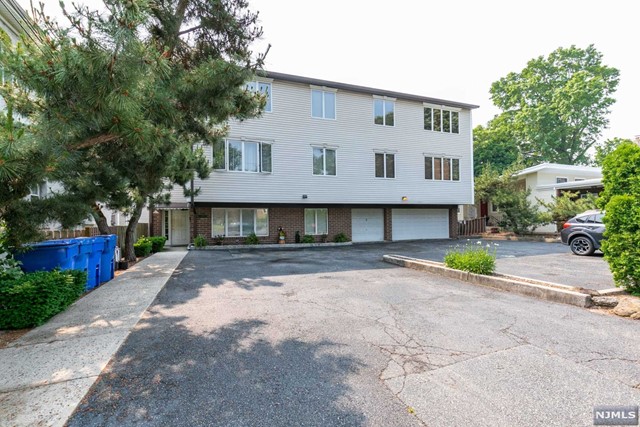Impeccable light filled large condo with everything you need! Huge rooms, great closets including a linen closet, new modern white kitchen with stainless appliances, gas range and dishwasher. Wonderful views throughout the open feel apartment, beautiful hardwood floors and central air. In-unit full size laundry machines, young furnace and HWH. 1 Garage parking space w/workshop area and 1 outside parking space. Basement features common laundry and individual big storage closets for each unit. 2 blocks to NYC bus, about 4 blocks to Rutherford train station and very convenient to all that downtown Rutherford has to offer!
