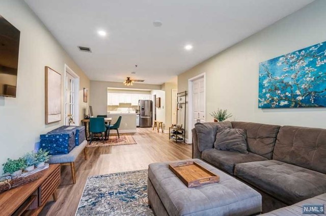 Spacious townhouse in a peaceful setting close to everything! Live the lifestyle you've dreamed about in this immaculate unit tucked into the beautifully landscaped & gated Cambridge Heights complex. With a pool & fitness center, this community is just minutes to parks, shops, restaurants, major highways, train station, & bus stop for an easy commute to NYC. Highlights include new floors & windows, recess lighting, abundant natural light, a patio & generous closet space. Beyond the foyer a full bathroom. The open layout flows into a large, sun-filled living room with sliding glass doors to a cozy, partially covered patio. The dining area is adjacent to the large, open kitchen equipped with granite counters, ample bright white cabinets & new SS appliances. French doors open to a spacious primary bedroom witha full en suite bathroom. The 2nd bedroom features a bay window and convenient inside access to the full hall bathroom. Move right in and enjoy luxurious, low maintenance living
