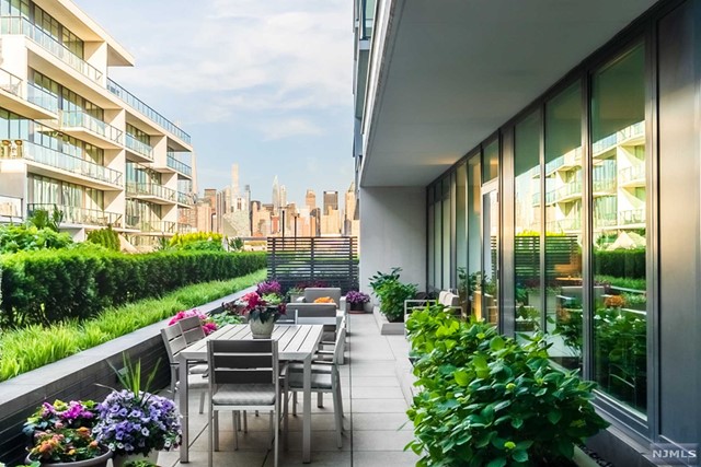 AVENUE COLLECTION 1200 - RESIDENCE 314 boasts the best of both indoor and outdoor living. It features 2194-sf plus an incredible private garden terrace with stunning New York skyline views. The massive floorplan starts with a wonderful open plan living area anchored by a truly impressive peninsula kitchen. It continues with a separate bedroom wing that optimizes privacy and is punctuated by a master suite with a spa-inspired windowed bathroom. Exquisite finishes include warm woods, luscious stone, quality fixtures & appliances. A private back door entry, side-by-side laundry, custom built-ins & vast custom-fitted closets plus 2 tandem garage parking spaces complete this one-of-a-kind and highly sought after home. The exclusive Building 1200 amenities include 24-hour concierge, health club, movie theatre, penthouse level sky lounge, and the incredible 3rd level resort-style plaza with pool and fire pit lounge all with spectacular views.
