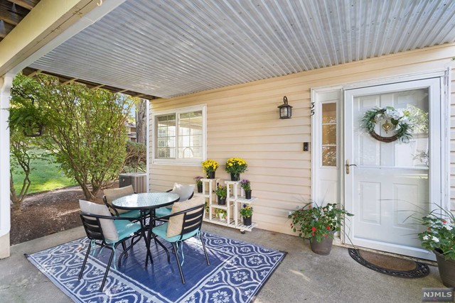 Welcome to this bright and sun-filled, ground-level, end-unit home, all on one floor. This warm and inviting space boasts numerous upgrades, including a fully renovated kitchen with granite countertops, a stylish tile backsplash, stainless steel appliances, and a brand-new floor. Wrap-around windows showcase the best views in the neighborhood and lead to a cozy fireplace and beautiful hardwood floors in the open living and dining areas. The home features 2 spacious bedrooms, each with its own full bathroom and multiple closets for ample storage. The primary bedroom offers complete privacy. A new washer and dryer are also included for added convenience. Step outside to enjoy a peaceful, spacious patio perfect for relaxation. The home includes an attached garage for easy access.Located in the desirable Fieldstone section of The Hills of Bedminster.